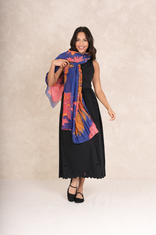Woman wearing a black dress with a colorful scarf on a beige background.
One Hundred Stars Crane Cobalt Scarf