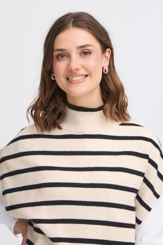 Fransa Bitte Poncho in Limestone Melange. Woman wearing a cream and black striped sweater against a white background