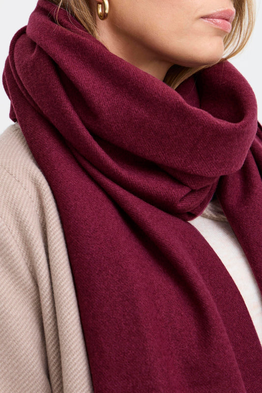 Fransa Pasmira Scarf in Fudge Melange. Close-up of a person wearing a burgundy scarf with a neutral background