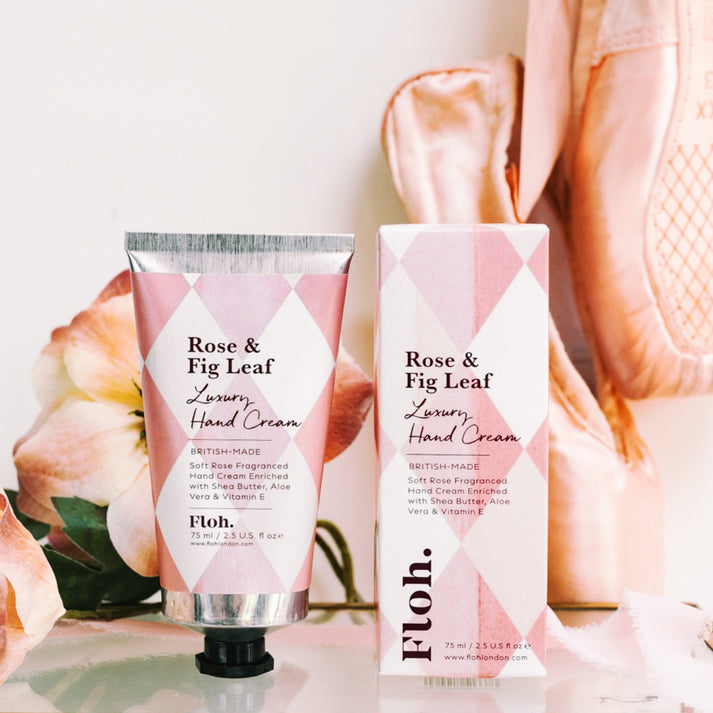 Toasted Crumpet Rose & Fig Leaf Luxury Hand Cream - A tube and box of Floh. Rose & Fig Leaf Luxury Hand Cream, styled with pink flowers and a soft pink background.