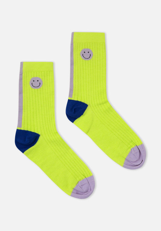 Pair of bright green socks with smiley face designs on a white background