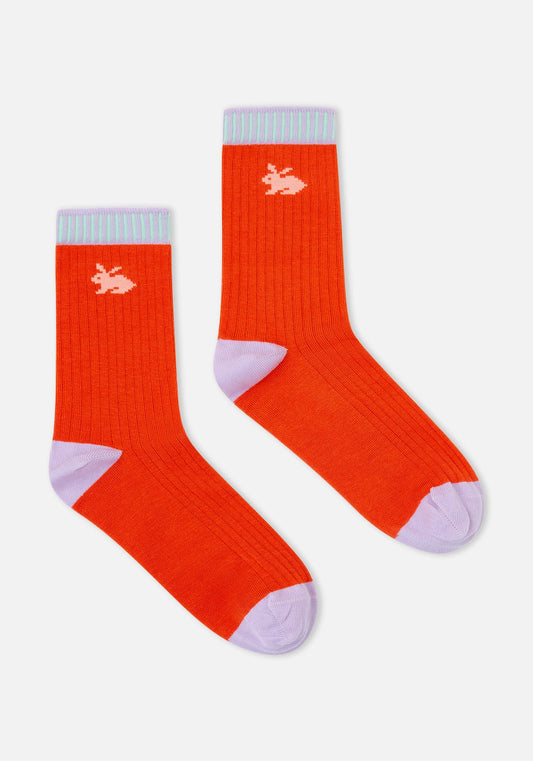 Pair of orange socks with light blue accents on a white background