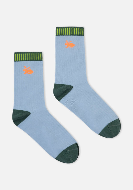 Pair of light blue socks with green accents and orange accents on a white background