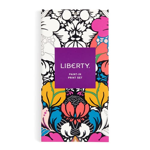 Liberty Paint-In Print Set featuring a vibrant floral pattern with a central purple label. The pattern showcases a mix of pink, yellow, blue, black, and white floral motifs.
