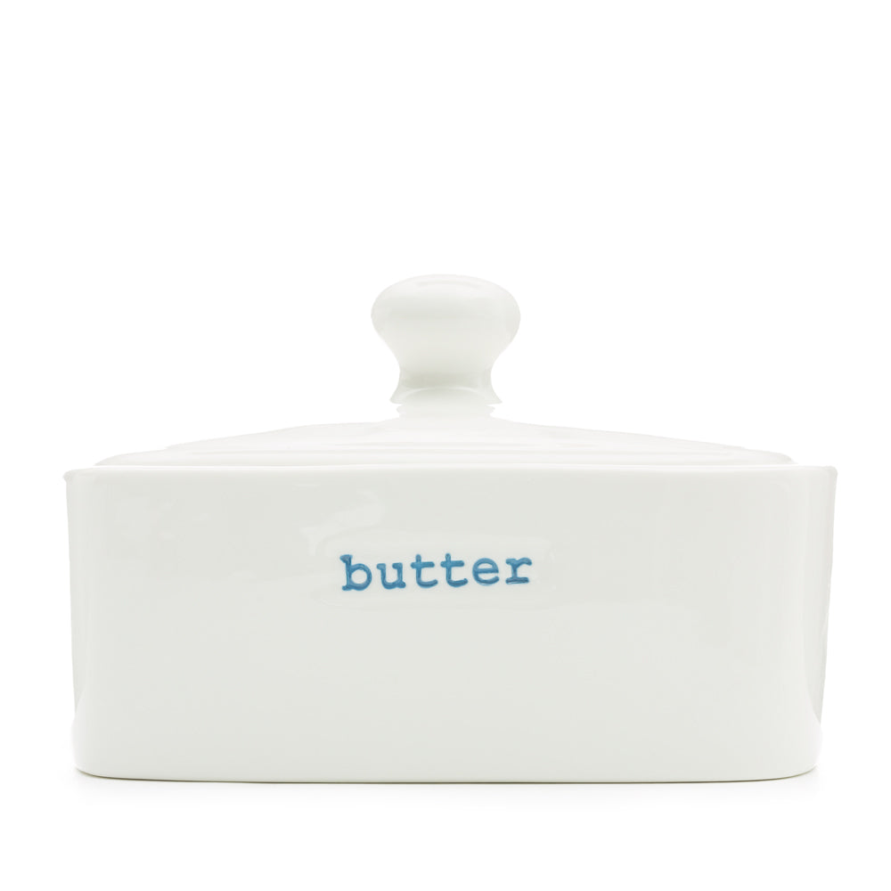 White ceramic butter dish with 'butter' label on a white background