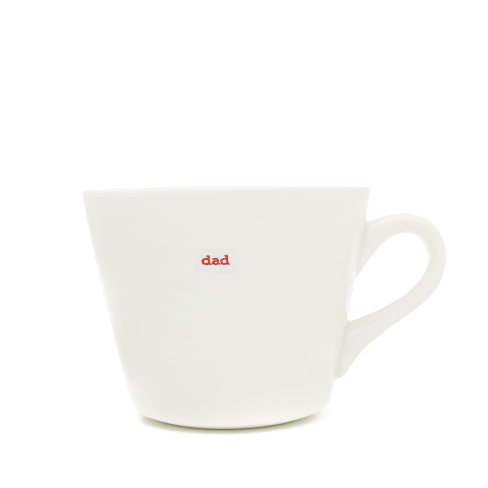 White mug with 'dad' printed in red on a white background