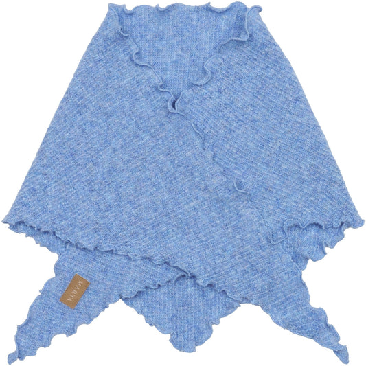 Marta Agnete Scarf in Jeans - a light blue knit poncho-style wrap with ruffled edges and pointed triangular ends, shown flat against a white background. A small tan fabric tag is attached near one corner.