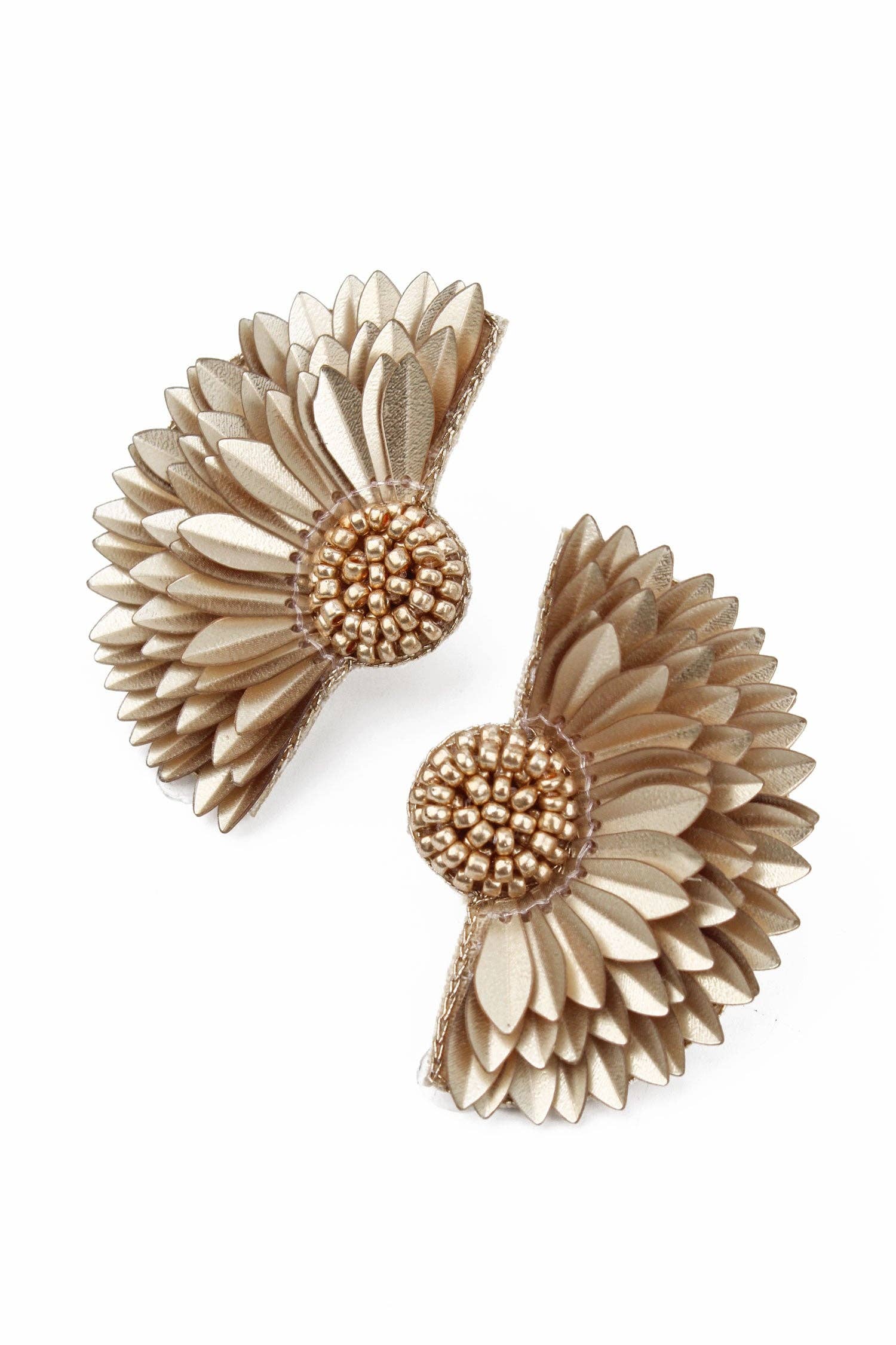 Pair of gold and beige floral earrings on a white background