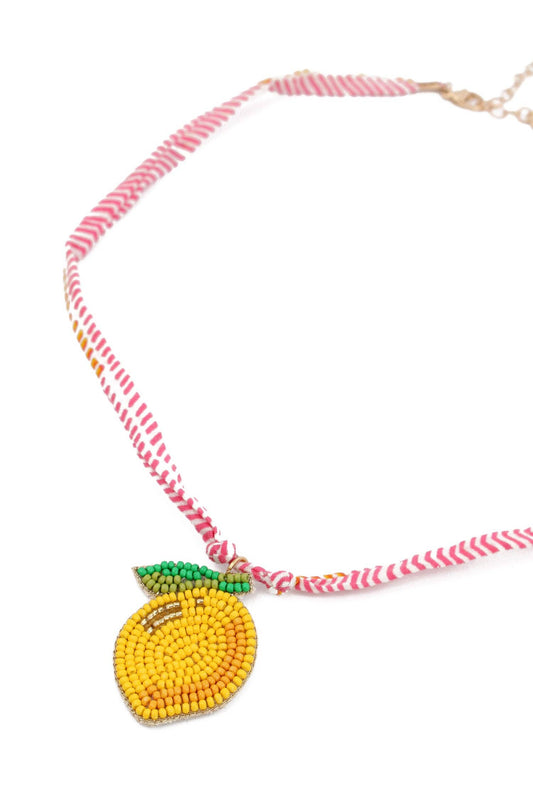 My Doris Necklace with a beaded lemon pendant on a white background