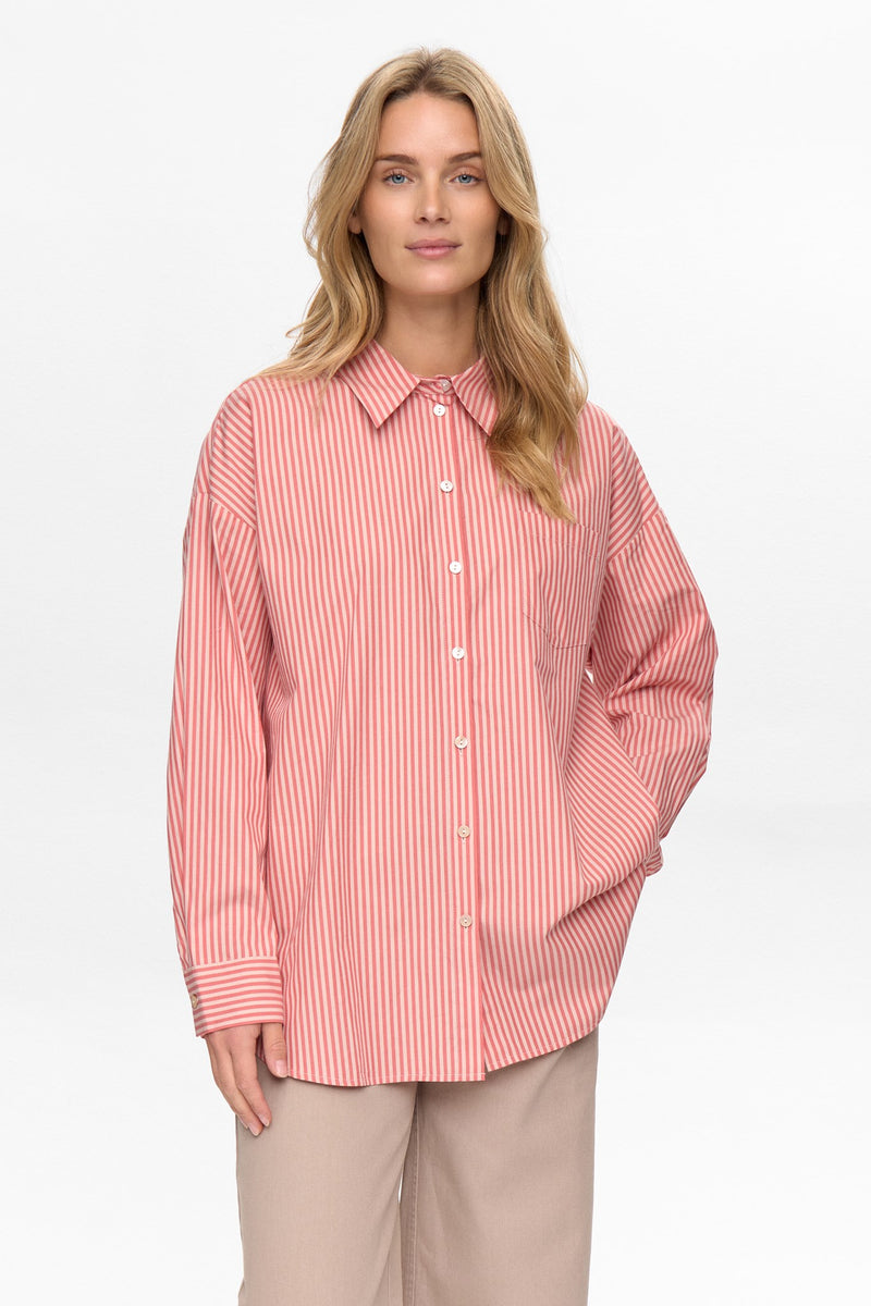 Woman wearing a red and white striped shirt on a white background