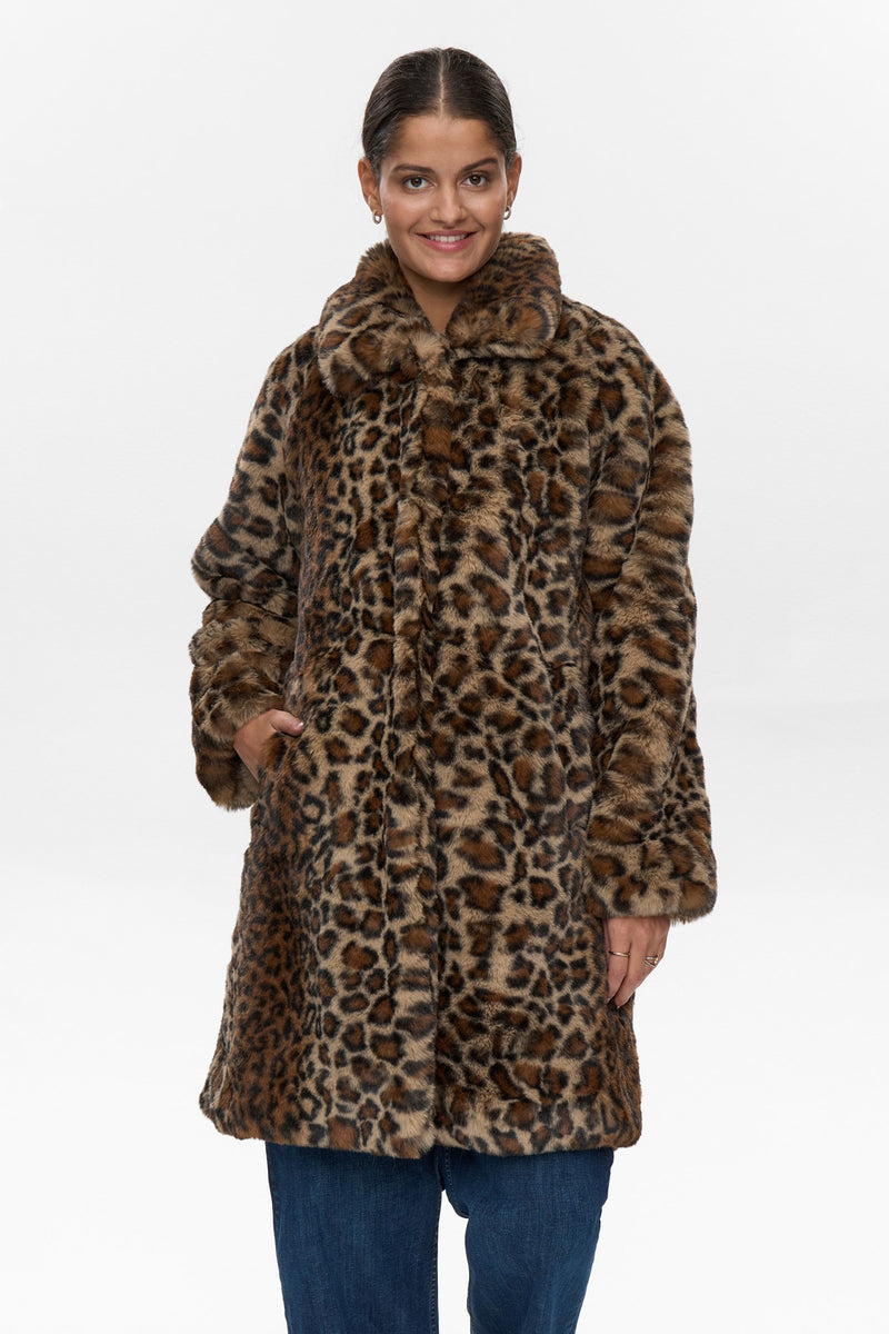 Woman wearing a leopard print coat on a white background