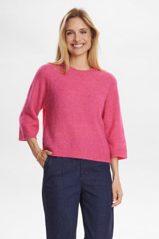 Numph Nurietta Selma Pullover in Fandango Pink Woman wearing a pink sweater and blue pants on a white background