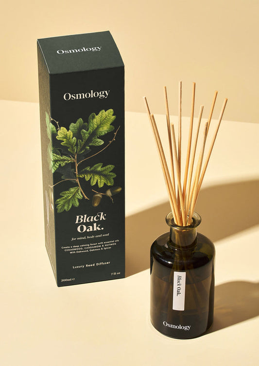 Osmology Black Oak diffuser bottle and packaging on a beige background