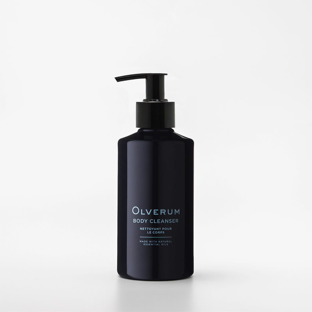 Black bottle of Olverum body cleanser on a white background