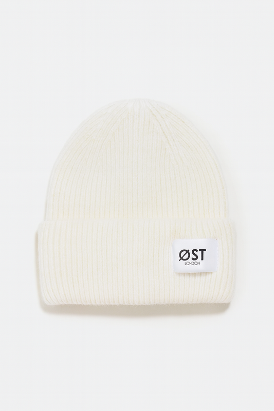White beanie with a logo on a white background