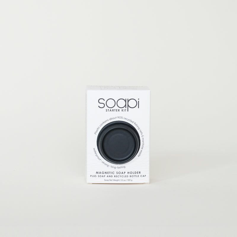 Soapi starter kit packaging with a black soap holder on a light gray background