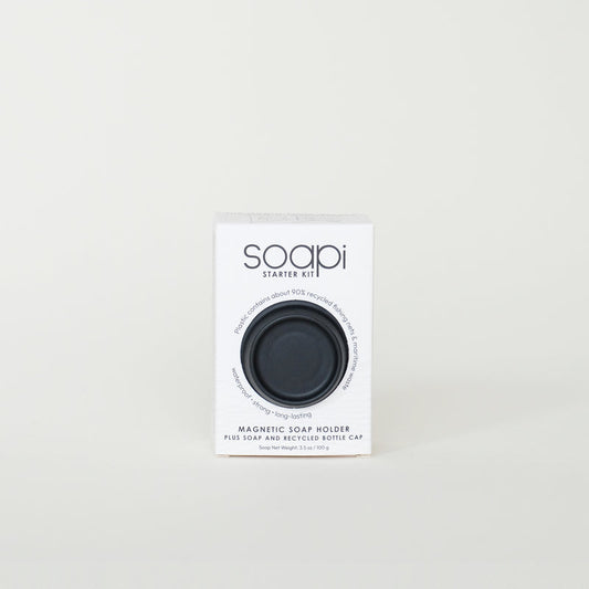 Soapi starter kit packaging with a black soap holder on a light gray background