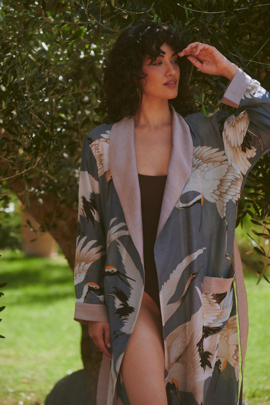 Woman wearing a floral grey kimono in a park setting
