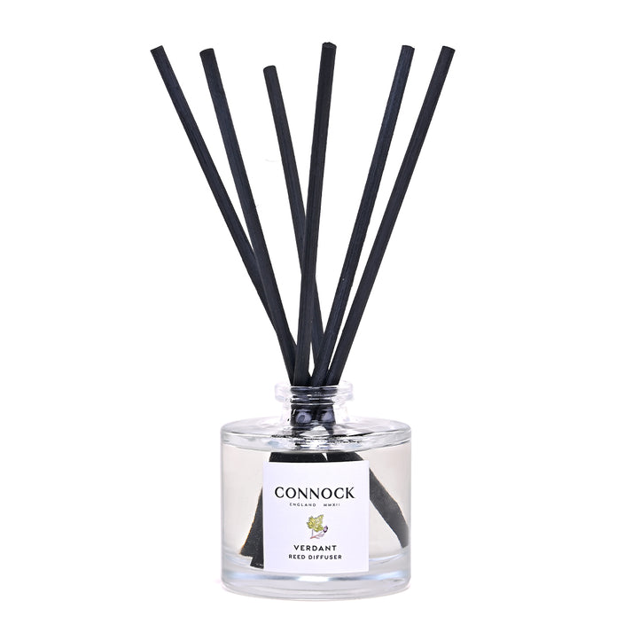 Connock Verdant Reed Diffuser featuring a clear glass bottle with a white label and six black reed sticks, photographed on a solid white background.