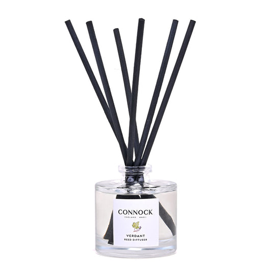 Connock Verdant Reed Diffuser featuring a clear glass bottle with a white label and six black reed sticks, photographed on a solid white background.