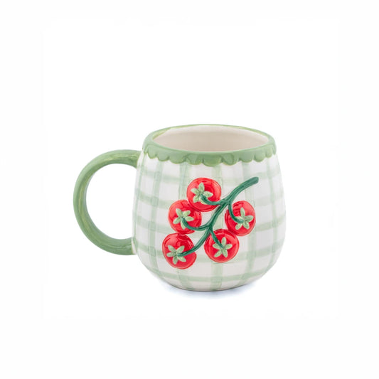 Ceramic mug with tomato design on a white background
