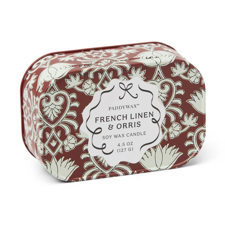 Candle packaging with floral design and label on a white background