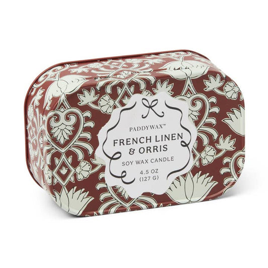 Candle packaging with floral design and label on a white background