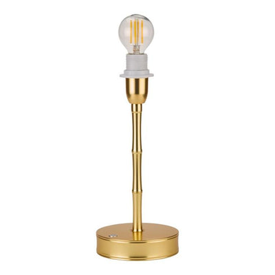 Gold table lamp with a clear light bulb on a white background