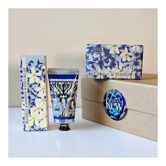 A hand cream tube and matching box with a blue and white floral print, displayed next to a kraft gift box with a blue circular sticker and a matching box labeled 'Blue Bell & Jasmine'.