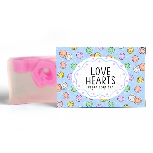 Vegan soap bar with a colorful packaging label featuring 'Love Hearts' text.