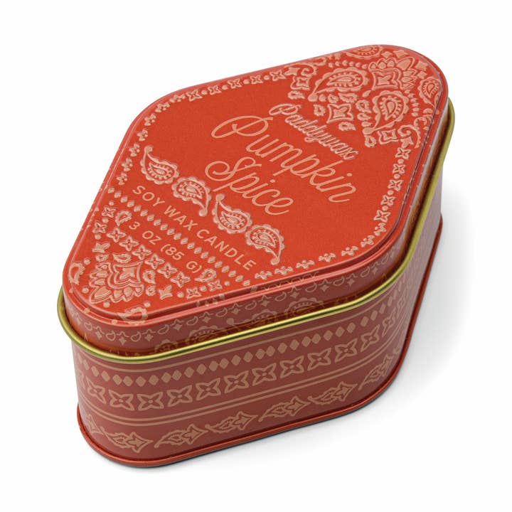 Pumpkin spice candle tin with decorative design on a white background