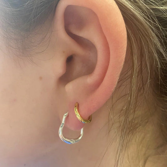 Reeves & Reeves Grace hoop earrings, in Gold palte or Sterling Silver, have an undulating shape and high shine finish. 