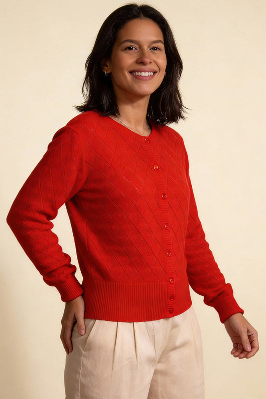 Woman wearing a red cardigan on a beige background