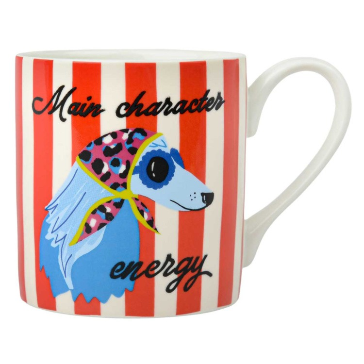 A white ceramic mug with red and white vertical stripes, featuring a colourful illustration of a blue dog wearing a pink leopard-print headscarf. The text 'Main character energy' is written in black script on the mug.
