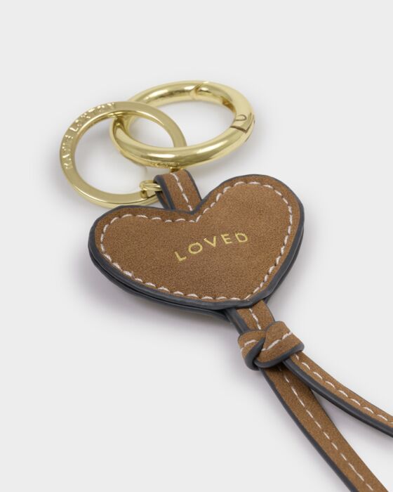 Heart-shaped keychain with 'LOVED' engraving on a white background