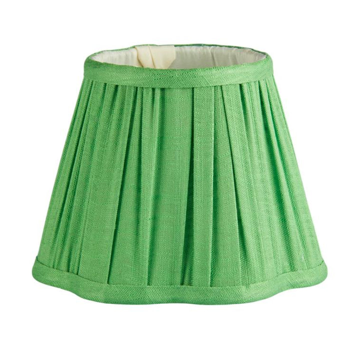 Green pleated lampshade on a white background