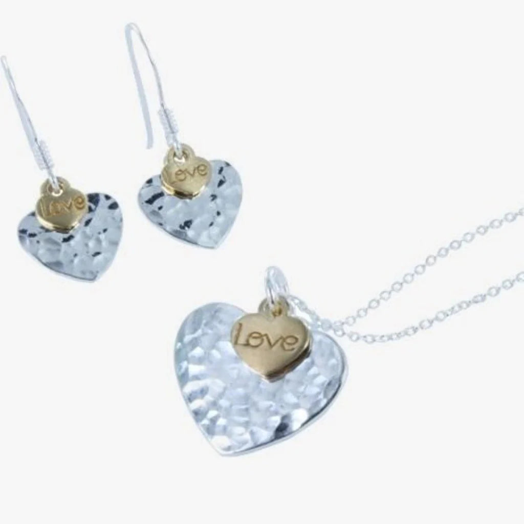 silver necklace with two hearts - one larger beaten silver heart and one smaller gold plated heart with the work love inscribed 