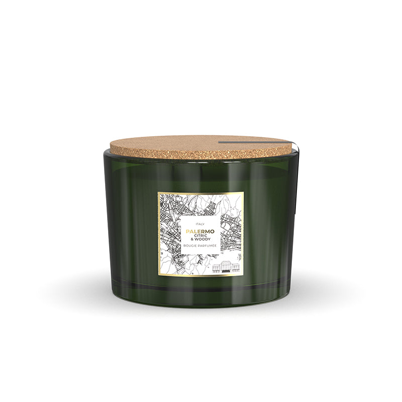 Green candle with cork lid on a white background