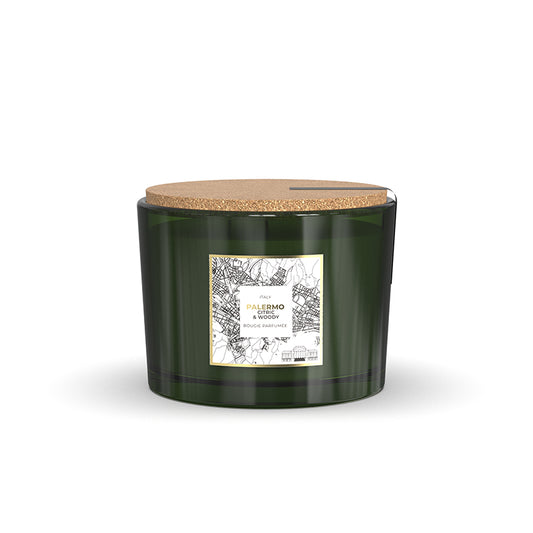 Green candle with cork lid on a white background
